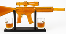 Alcohol decanter shaped like a rifle with two glasses on a white background