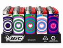 A retail display of BIC lighter refill packs in a black plastic tray. The five packs feature colorful spiral patterns with hearts: black and purple, green and purple, green, blue, and pink, and red tops.
