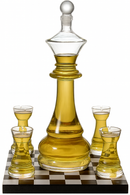 Glass chess piece set with a decanter and cups on a checkered base