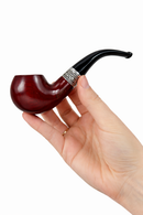 Hand holding a wooden pipe with a silver band against a white background