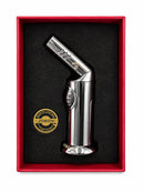 A polished chrome JOBON torch lighter presented in a red gift box with a black foam insert and a round gold JOBON emblem, photographed on a white background.