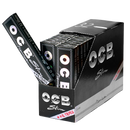 A display box of OCB Slim Premium Rolling Papers with several individual packs visible, featuring the OCB logo and the word 'Slim' on the packaging.