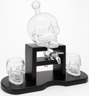 Skull-shaped decanter set with two glasses on a white background