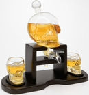 Skull-shaped decanter with two glasses on a white background